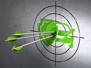 Image showing Insurance concept: arrows in Car And Shield target on wall background