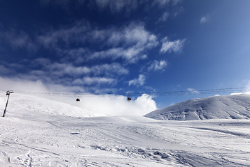 Image showing Gondola lift and ski slope at sun day