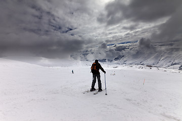 Image showing Skiers on ski slope before storm