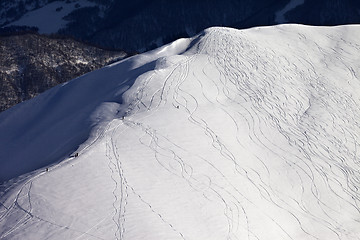 Image showing Top view on off piste slope with snowboarders and skiers in even