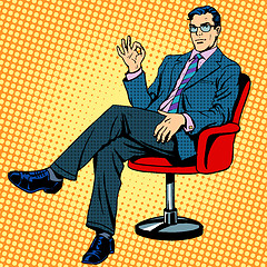 Image showing Businessman sitting in an armchair gesture okay