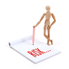 Image showing Wooden mannequin writing - Risk
