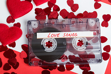 Image showing Audio cassette tape on red background with fabric heart