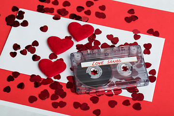 Image showing Audio cassette tape on red background with fabric heart