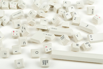 Image showing scattered keyboard keys on white 