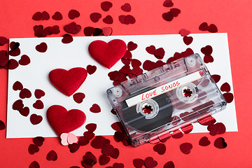 Image showing Audio cassette tape on red background with fabric heart