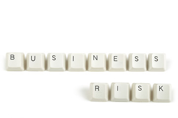 Image showing business risk from scattered keyboard keys on white