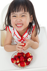 Image showing Asian Chinese little girl eating strawberries