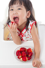 Image showing Asian Chinese little girl eating strawberries