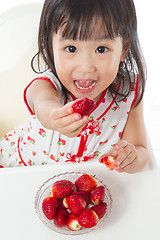 Image showing Asian Chinese little girl eating strawberries