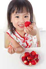 Image showing Asian Chinese little girl eating strawberries