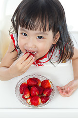 Image showing Asian Chinese little girl eating strawberries