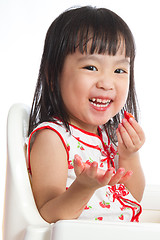 Image showing Asian Chinese little girl eating strawberries