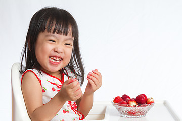 Image showing Asian Chinese little girl eating strawberries