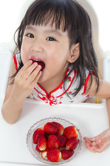 Image showing Asian Chinese little girl eating strawberries