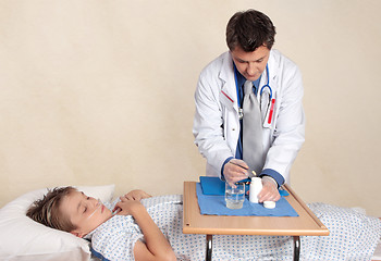 Image showing Doctor preparing medication dose
