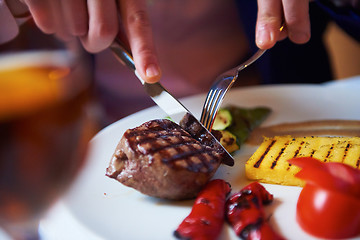 Image showing business man eating tasty beef stak