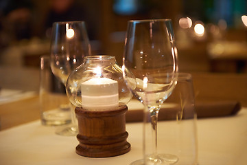 Image showing Wine bottles on a wooden shelf.