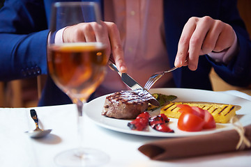 Image showing business man eating tasty beef stak