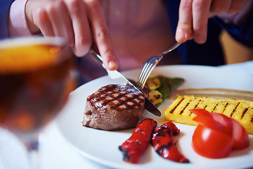 Image showing business man eating tasty beef stak