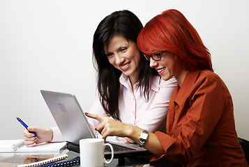 Image showing two beautiful women are working