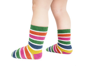Image showing Toddler standing in striped socks and bare legs isolated on whit