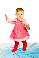 Image showing baby girl standing on a blue blanket. Studio photo