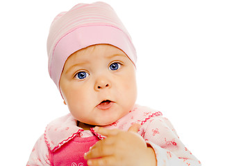 Image showing baby girl in a pink dress and hat. Portrait. Studio. Isolated.