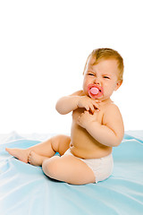 Image showing upset baby in diapers. Studio