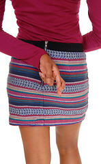 Image showing Woman in skirt from back, crossed finger.