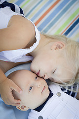 Image showing Little Sister Laying Next to Her Baby Brother on Blanket