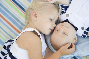 Image showing Little Sister Laying Next to Her Baby Brother on Blanket