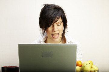 Image showing beautiful caucasian woman with laptop singing