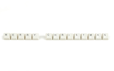 Image showing merry christmas from scattered keyboard keys on white