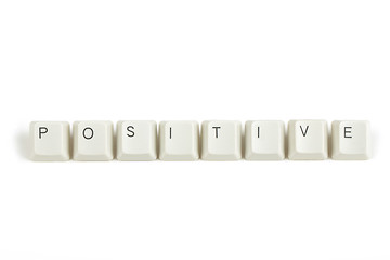 Image showing positive from scattered keyboard keys on white