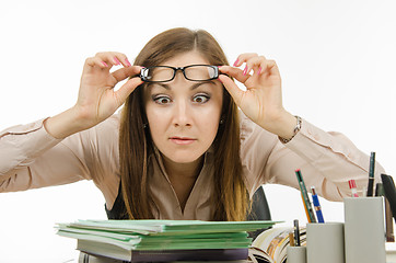 Image showing The teacher stares at the pile of notebooks