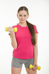 Image showing Sportswoman doing exercises with dumbbells