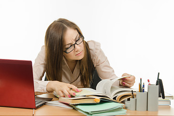 Image showing Teacher reading something in a textbook