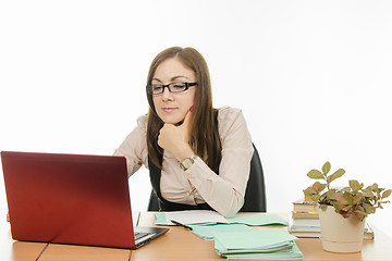 Image showing The teacher with glasses working on a laptop