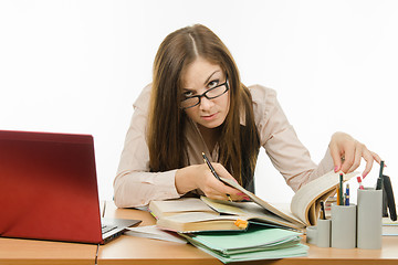 Image showing Teacher looking for information in a book