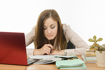 Image showing The teacher carefully checks written in the notebook