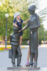 Image showing The girl climbed on the monument to the first teacher