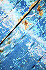 Image showing nail stripped   in the blue wood door  rusty 