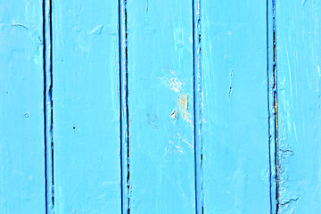 Image showing stripped paint in   blue wood door  nail