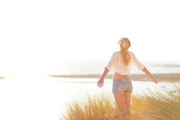 Image showing Free Happy Woman Enjoying Sun on Vacations.