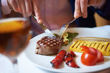 Image showing business man eating tasty beef stak