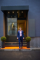 Image showing business man entering  hotel