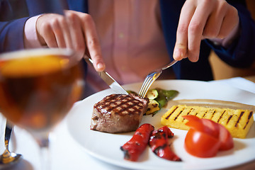 Image showing business man eating tasty beef stak