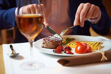 Image showing business man eating tasty beef stak