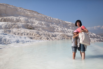 Image showing Mother and daughter on background of limestone of Pamukkale, Tur